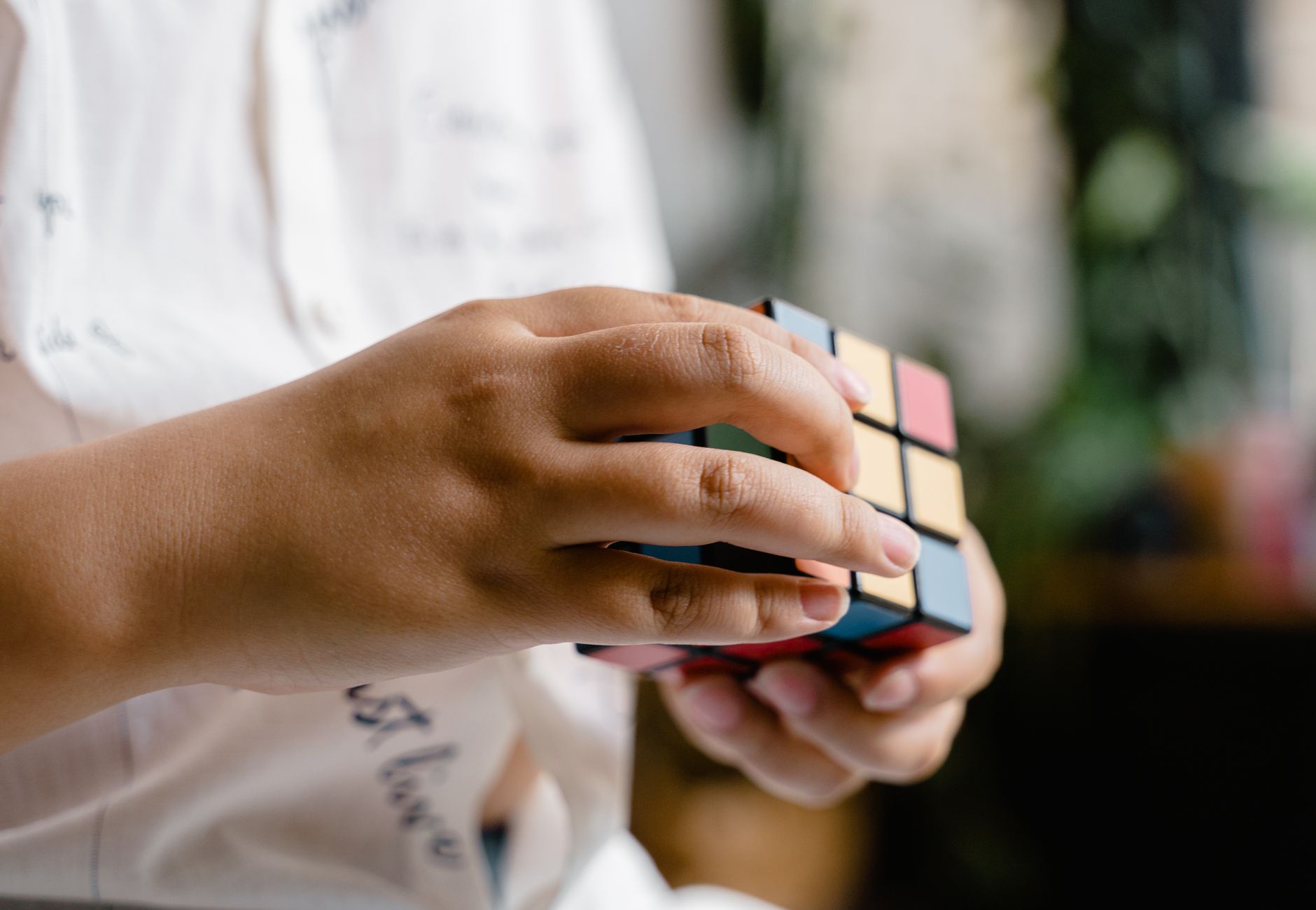 Hands manipulating a Rubik's Cube, showcasing concentration and skill.