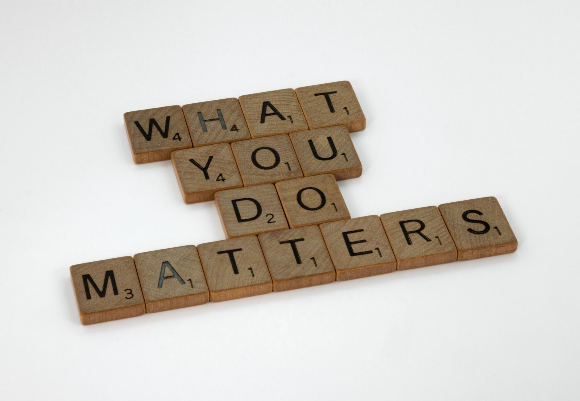 Wooden letter tiles spelling 'What You Do Matters' on a neutral background.